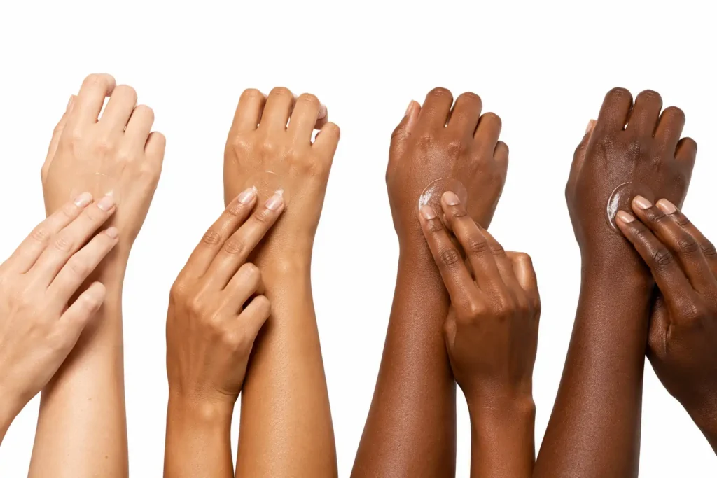 Illustration showing bemotrizinol-based sunscreen applying clearly on diverse skin tones with no white cast